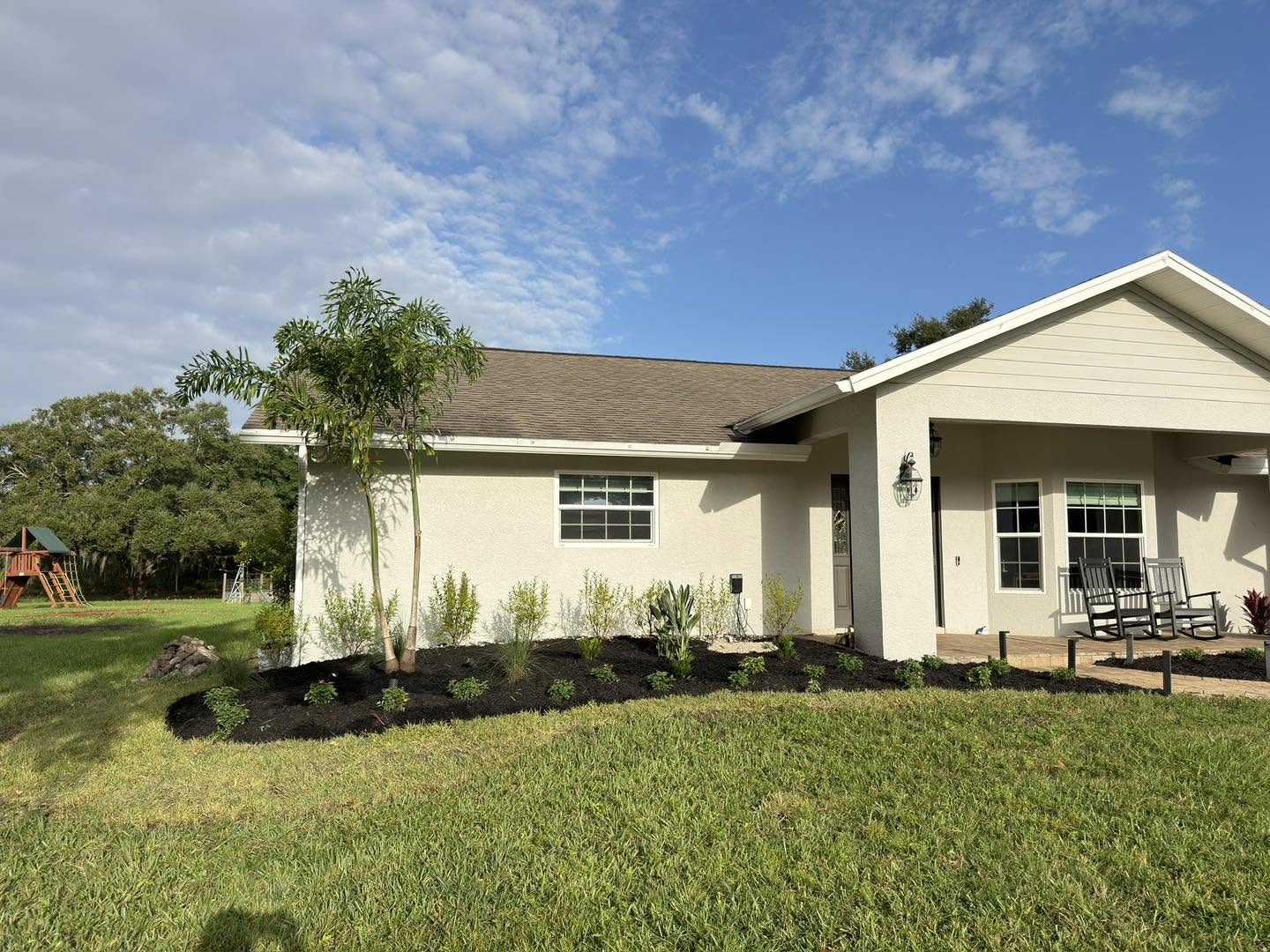 Palms and new planting beds surrounding a Florida home